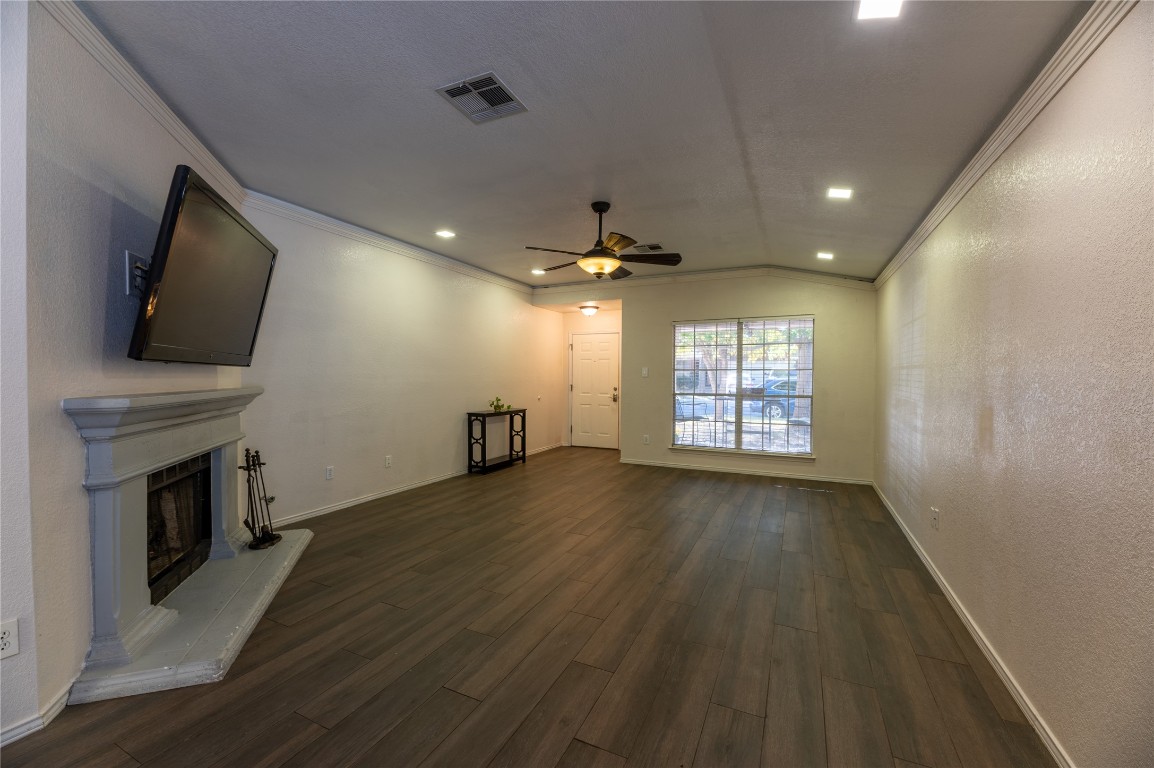 2604 Hutton Lane Leander, TX 78641 - Photo 6 of 27 a view of an empty room with wooden floor and a fireplace