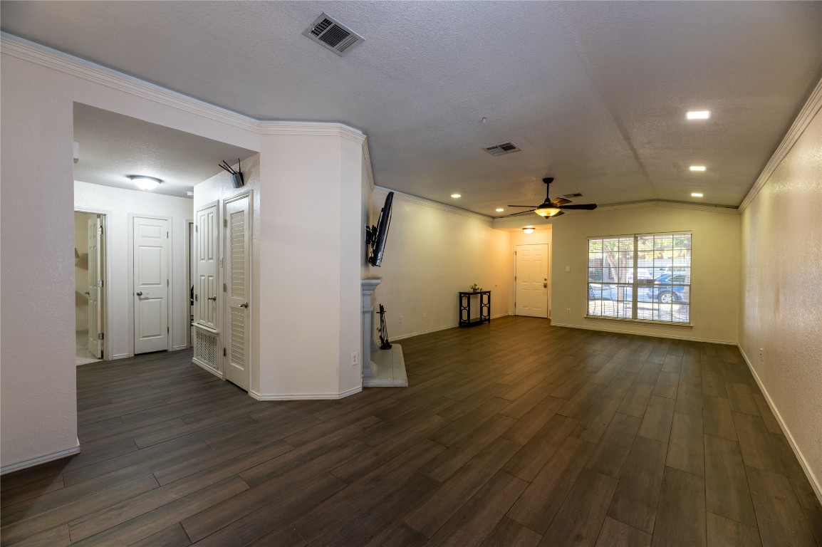 2604 Hutton Lane Leander, TX 78641 - Photo 7 of 27 a view of an empty room with wooden floor and a window