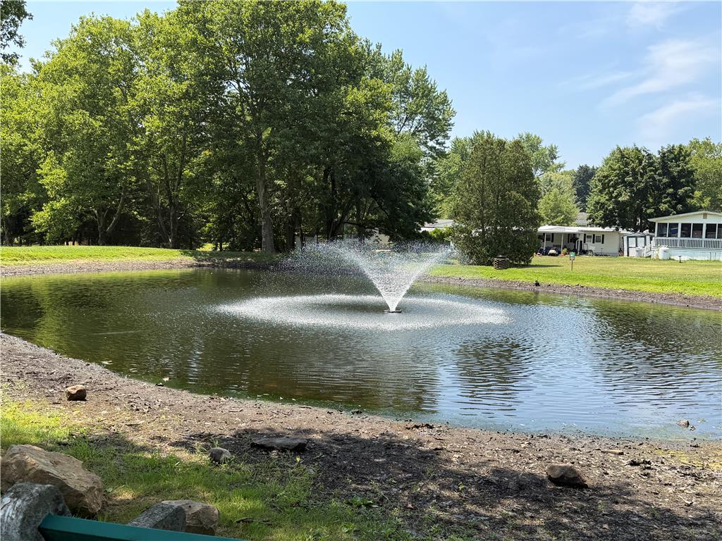 12 Springridge Road Bath, PA 18014 - Photo 66 of 70 A tranquil pond with a central fountain graces the verdant landscape, offering serene outdoor appeal.