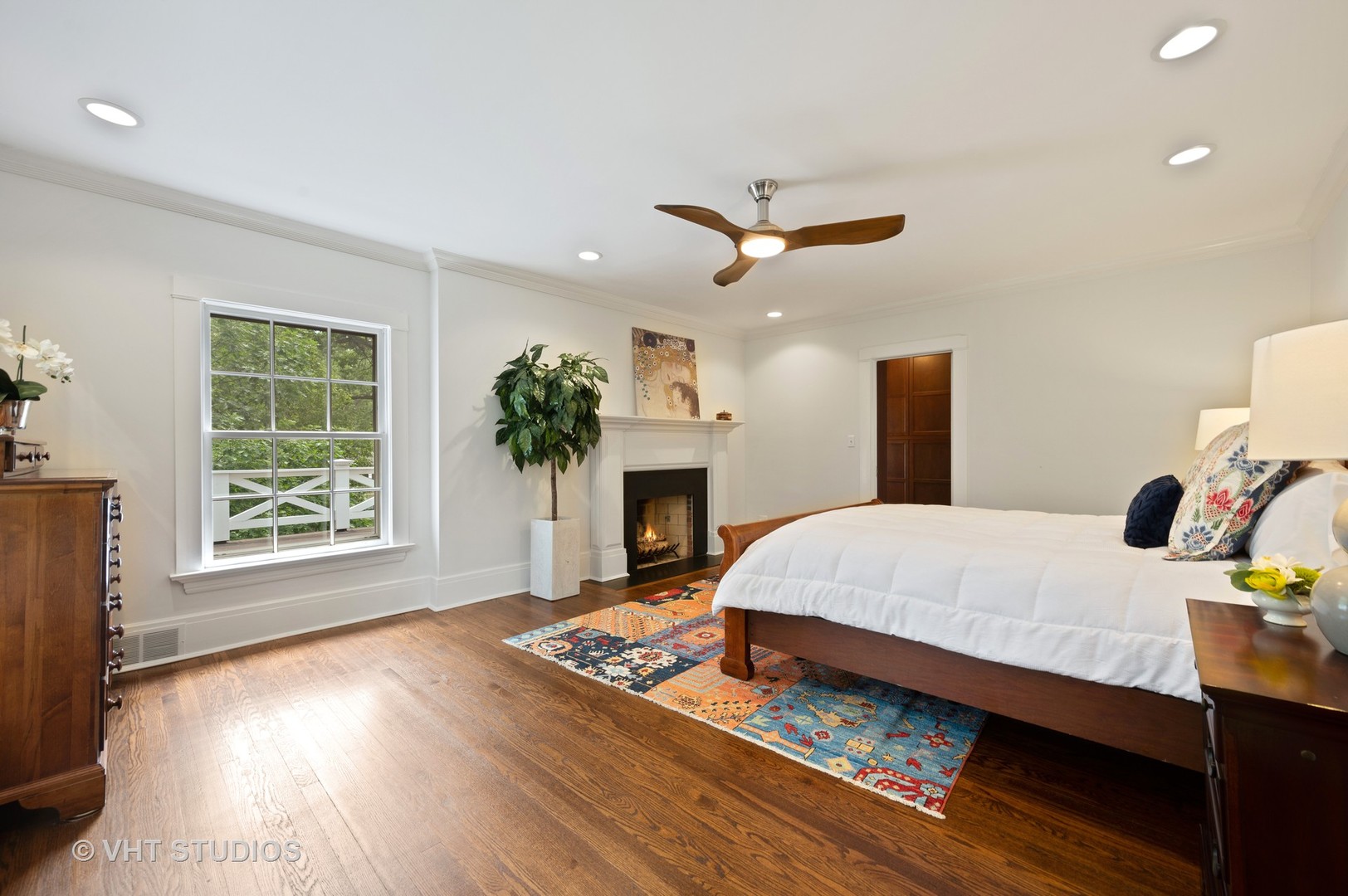 1010 Chestnut Avenue Wilmette, IL 60091 - Photo 20 of 48 a spacious bedroom with a large bed and a fireplace