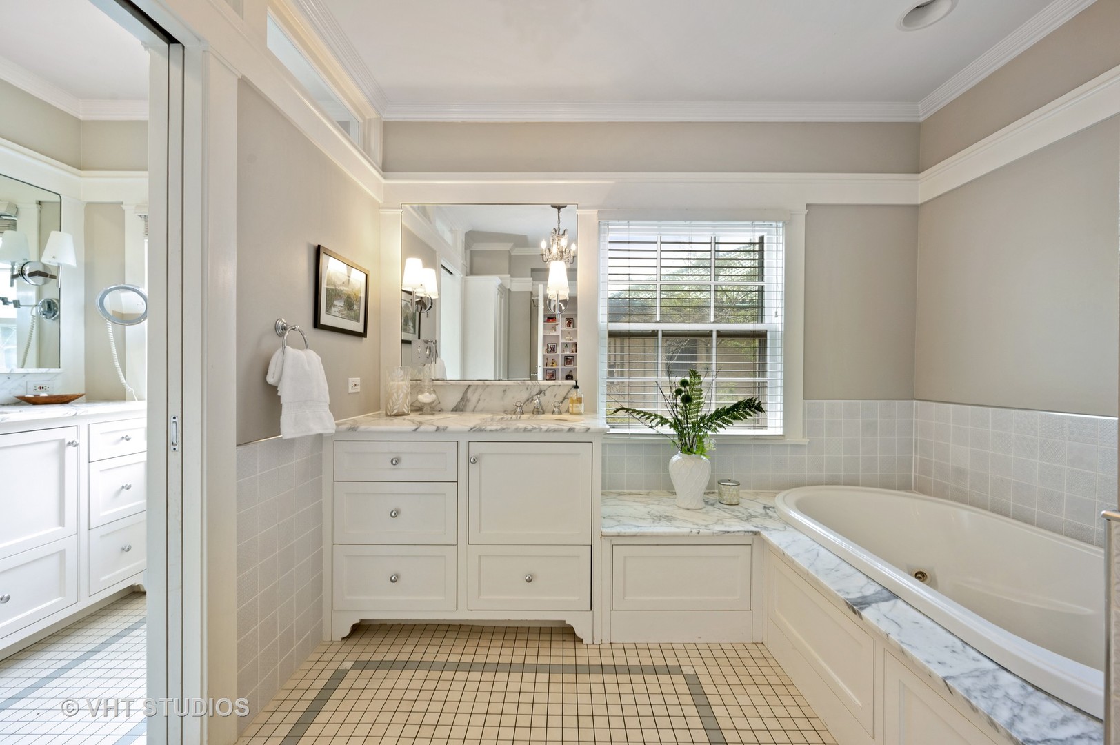 1010 Chestnut Avenue Wilmette, IL 60091 - Photo 21 of 48 a bathroom with a granite countertop sink a large mirror a bathtub and next to a window