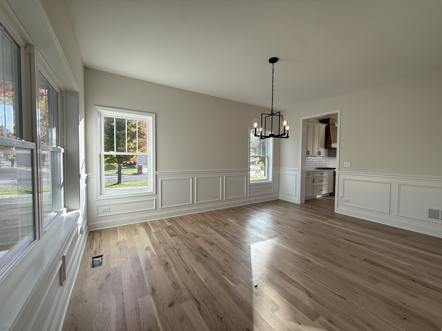1920 Edmonds Avenue New Lenox, IL 60451 - Photo 13 of 35 an empty room with wooden floor wooden cabinet and windows