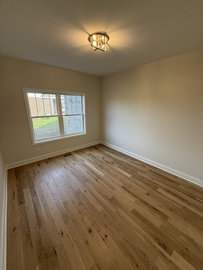 1920 Edmonds Avenue New Lenox, IL 60451 - Photo 15 of 35 an empty room with wooden floor and windows
