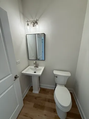 a bathroom with a sink toilet and mirror