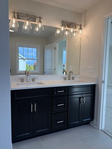 a bathroom with a double vanity sink and a mirror