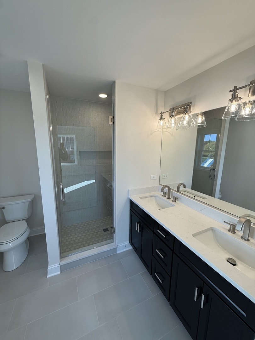 1920 Edmonds Avenue New Lenox, IL 60451 - Photo 20 of 35 a spacious bathroom with a double vanity sink toilet and shower