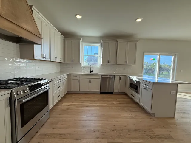 a large kitchen with a stove top oven
