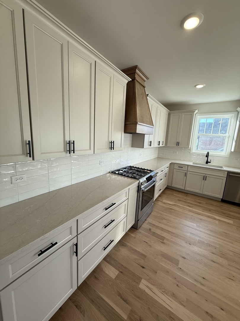 1920 Edmonds Avenue New Lenox, IL 60451 - Photo 7 of 35 a large kitchen with stainless steel appliances granite countertop a lot of counter space and wooden floors