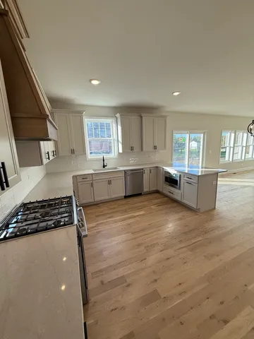 a kitchen with stainless steel appliances granite countertop a stove and a refrigerator
