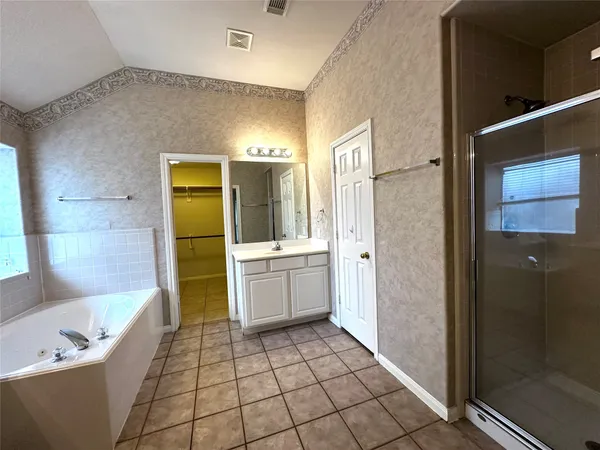 a bathroom with a bathtub and a shower