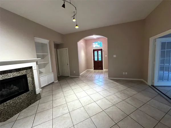 a view of a livingroom with a fireplace and window