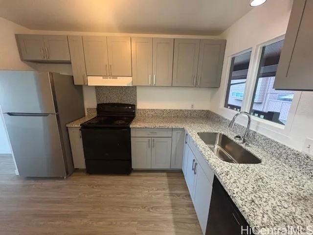 a kitchen with a sink stove and refrigerator