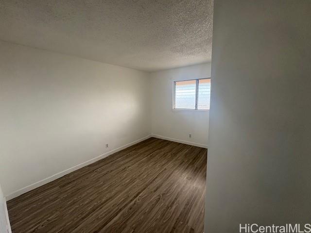 98-1370 Koaheahe Place, Unit 164 Pearl City, HI 96782 - Photo 9 of 12 an empty room with wooden floor and windows
