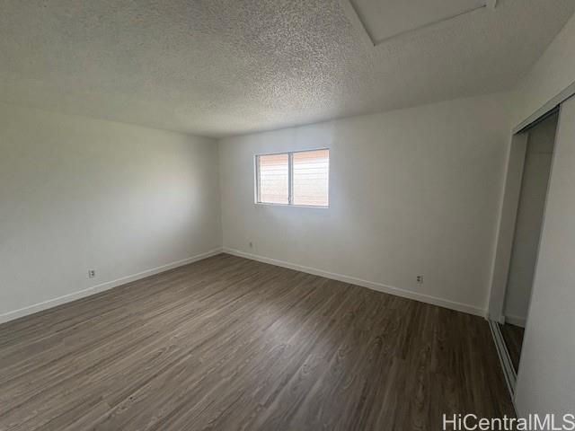 98-1370 Koaheahe Place, Unit 164 Pearl City, HI 96782 - Photo 10 of 12 an empty room with wooden floor and windows