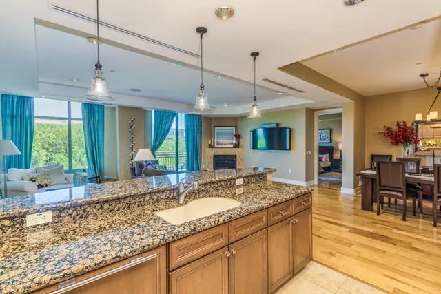a kitchen with granite countertop a sink and a counter top space