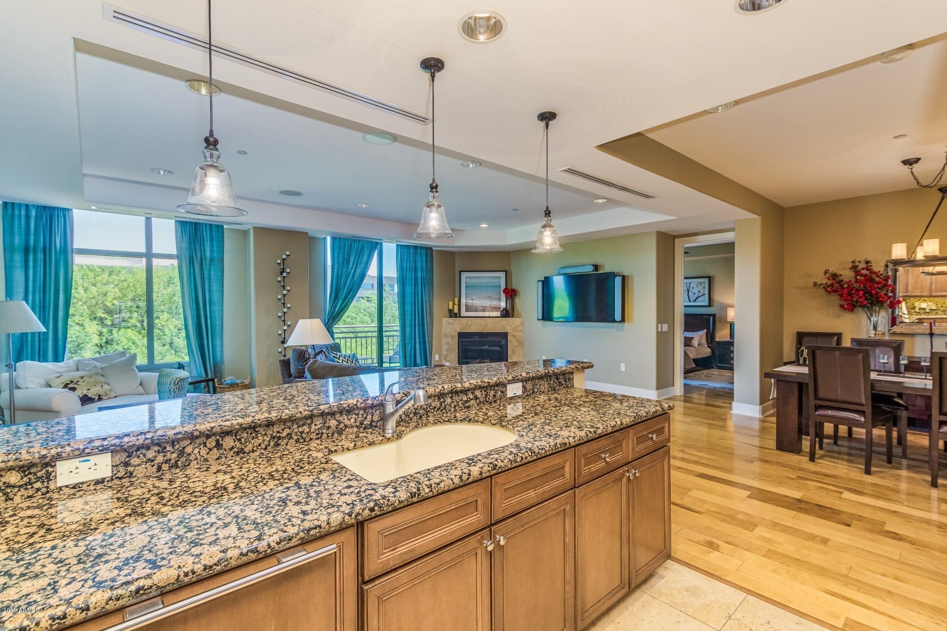 a kitchen with granite countertop a sink and a counter top space