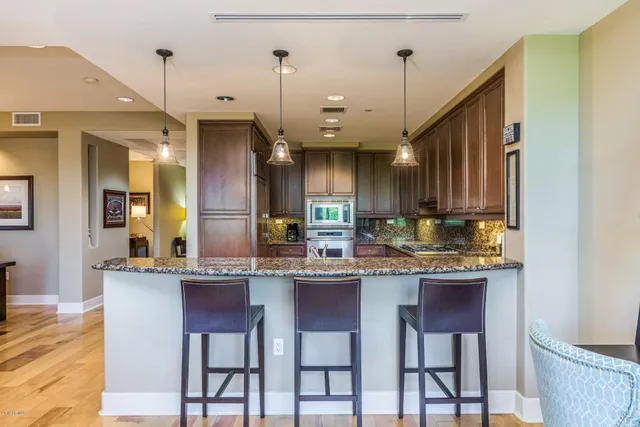 a kitchen with a refrigerator and a sink