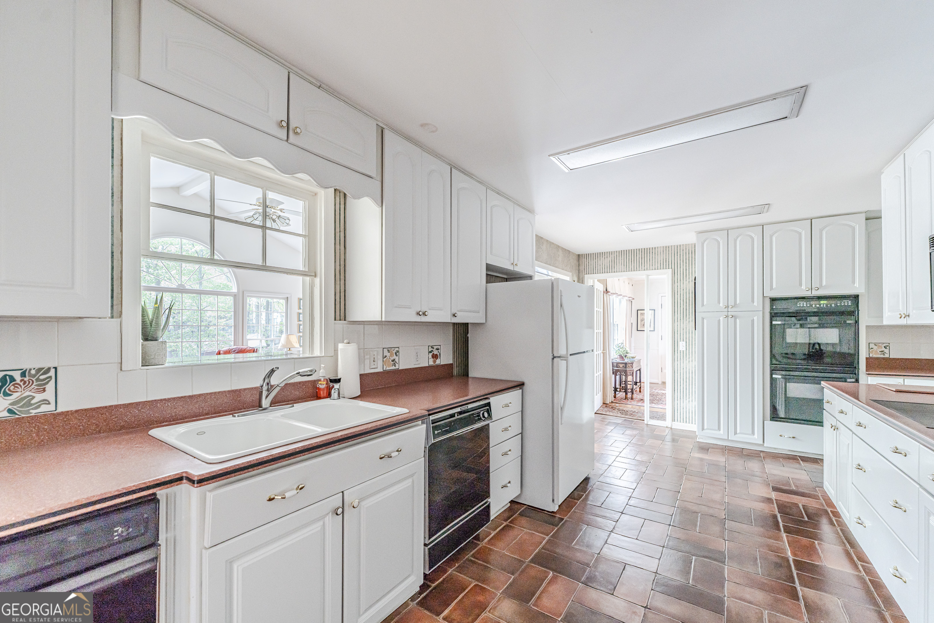 4 Windemere Lane Southeast Rome, GA 30161 - Photo 15 of 60 a kitchen with a sink stove and refrigerator