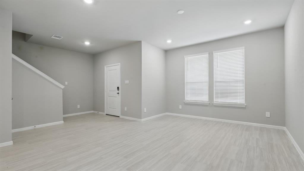 3152 Maple Orch Lane Fort Worth, TX 76140 - Photo 11 of 37 a view of an empty room with wooden floor and a window