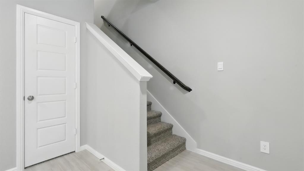 3152 Maple Orch Lane Fort Worth, TX 76140 - Photo 15 of 37 a view of staircase with white walls and white door