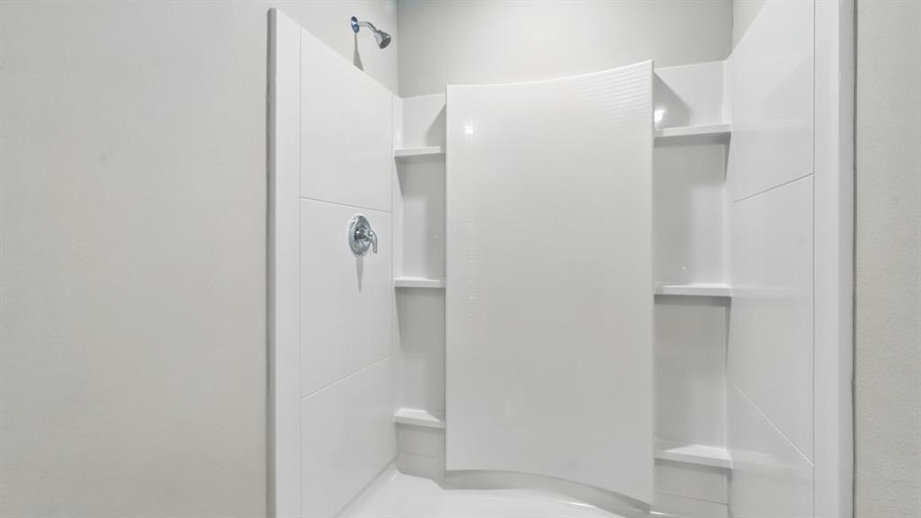 3152 Maple Orch Lane Fort Worth, TX 76140 - Photo 24 of 37 a bathroom with a shower and a toilet