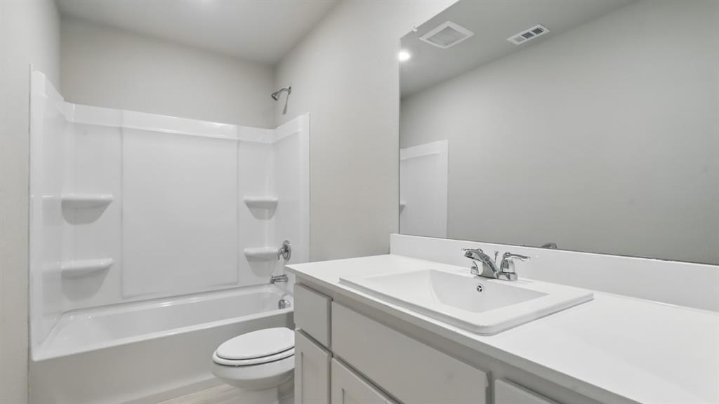 3152 Maple Orch Lane Fort Worth, TX 76140 - Photo 28 of 37 a bathroom with a sink a toilet and shower
