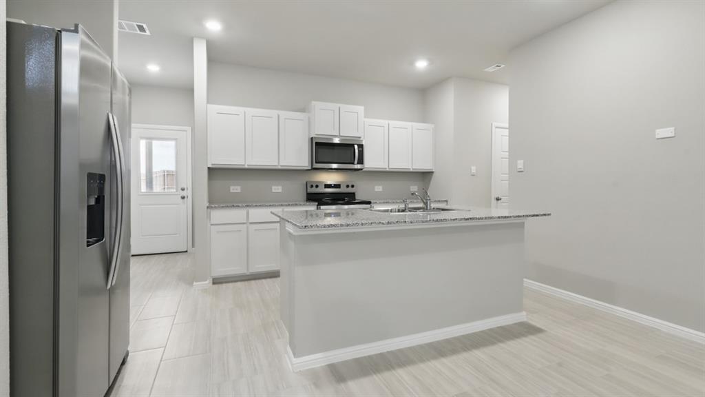 a kitchen with kitchen island white cabinets and stainless steel appliances