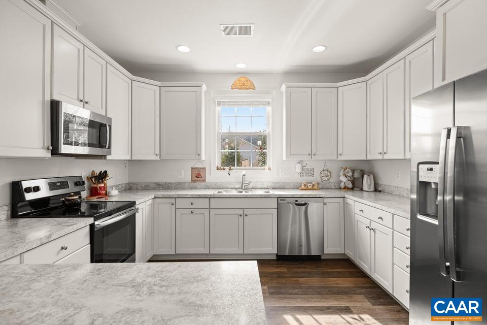 89 Crape Myrtle Drive Palmyra, VA 22963 - Photo 14 of 36 a kitchen with a sink stove and cabinets