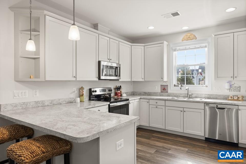 89 Crape Myrtle Drive Palmyra, VA 22963 - Photo 15 of 36 a kitchen with a sink stove and cabinets