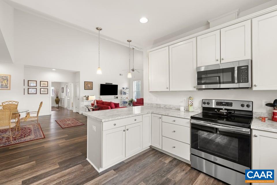 89 Crape Myrtle Drive Palmyra, VA 22963 - Photo 16 of 36 a kitchen with stainless steel appliances a stove microwave and cabinets