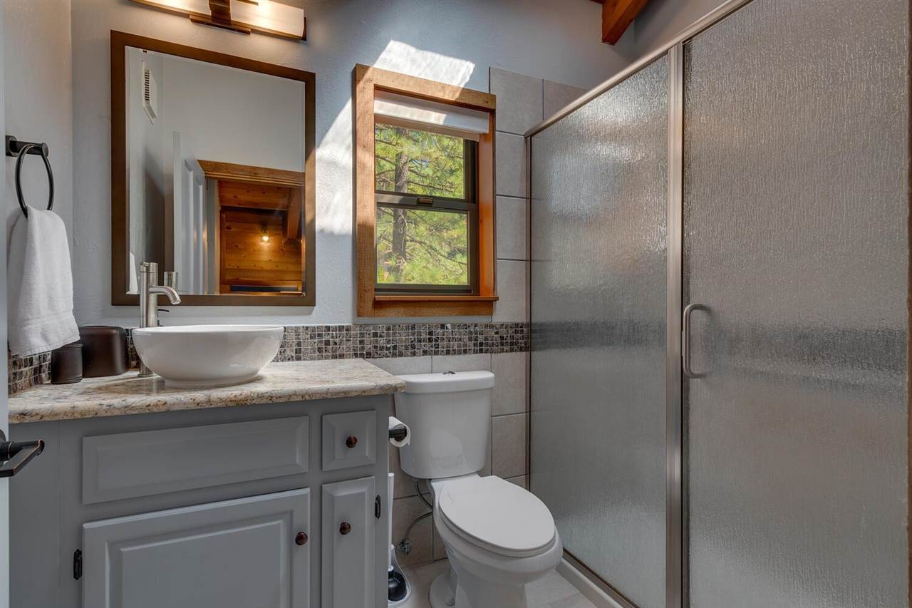 117 Basque Drive Truckee, CA 96161 - Photo 15 of 20 a bathroom with a granite countertop toilet sink shower and mirror