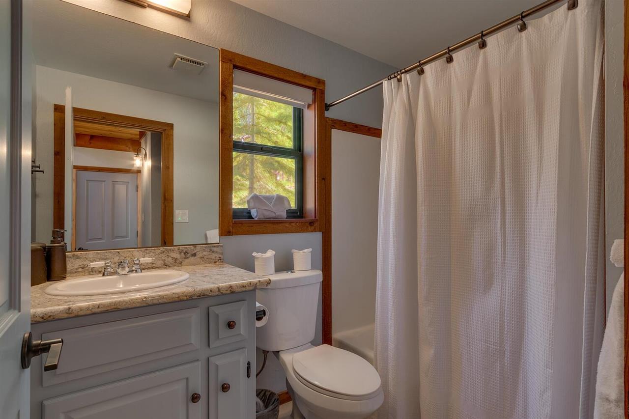 117 Basque Drive Truckee, CA 96161 - Photo 17 of 20 a bathroom with a granite countertop sink toilet and mirror