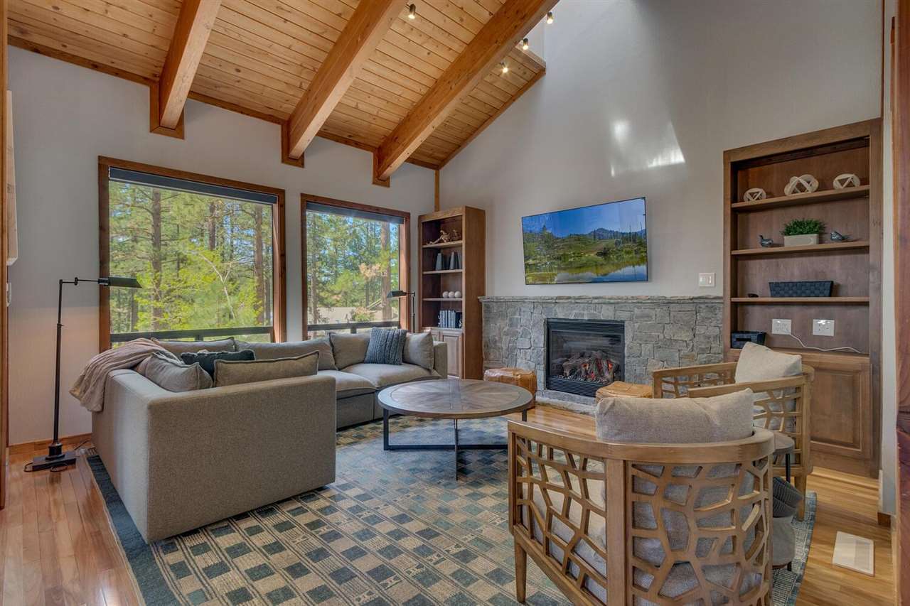117 Basque Drive Truckee, CA 96161 - Photo 3 of 20 a living room with furniture a fireplace and a large window