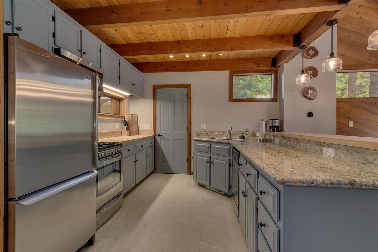 117 Basque Drive Truckee, CA 96161 - Photo 9 of 20 a kitchen with stainless steel appliances granite countertop a sink and a refrigerator