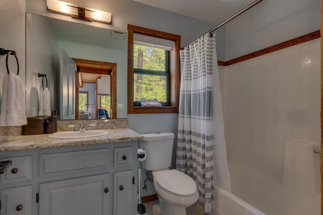 117 Basque Drive Truckee, CA 96161 - Photo 10 of 20 a bathroom with a granite countertop sink toilet mirror and shower
