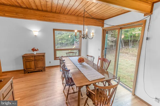 a kitchen with stainless steel appliances granite countertop a stove a sink dishwasher and a refrigerator with wooden cabinets