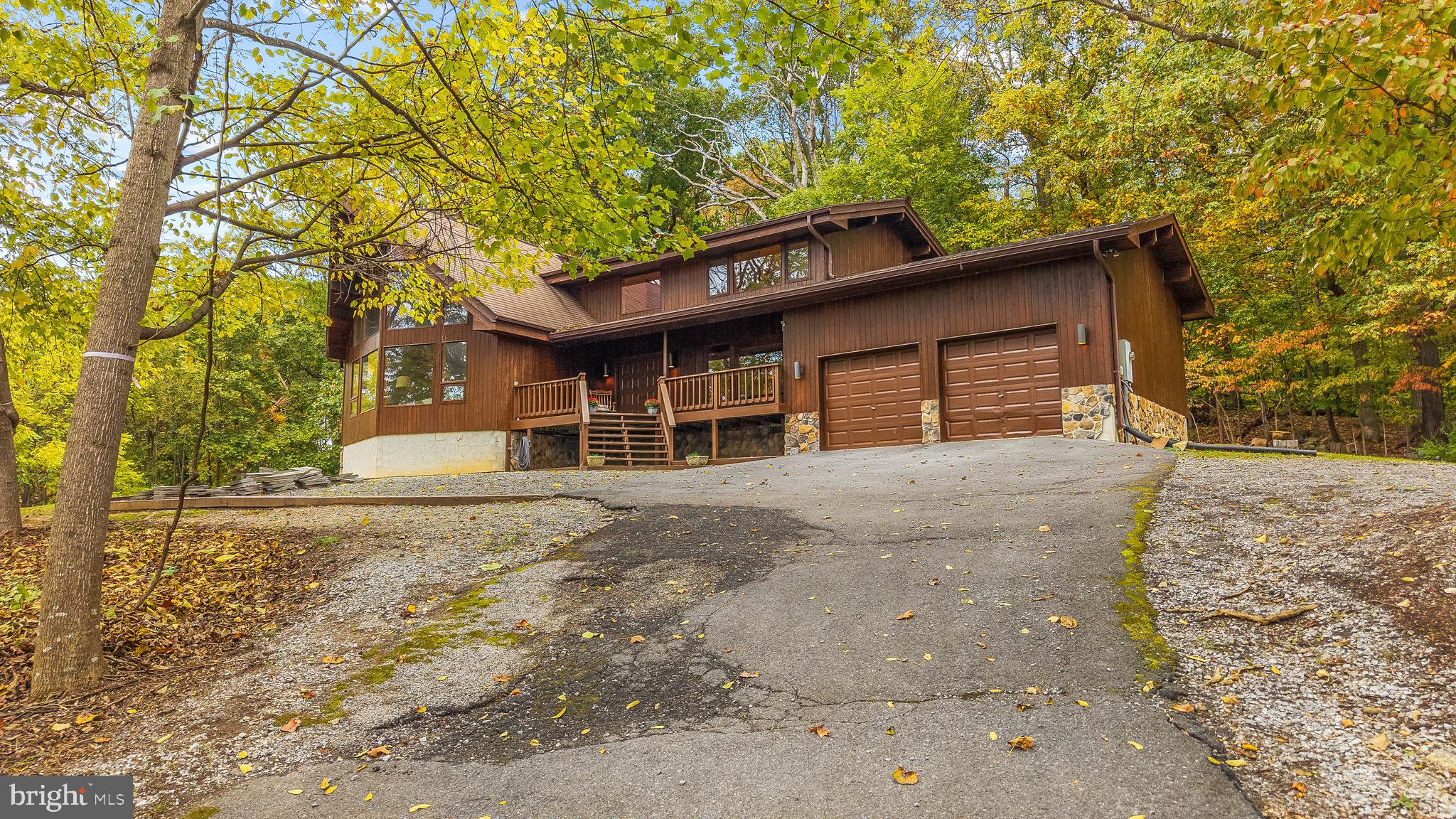 105 Rabbits Rest Lane Shepherdstown, WV 25443 - Photo 2 of 42 a house with trees in the background