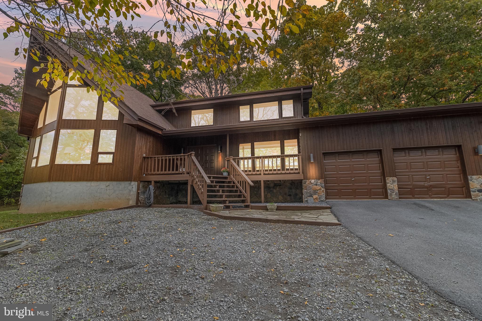 105 Rabbits Rest Lane Shepherdstown, WV 25443 - Photo 6 of 42 front view of a house with a large window and wooden fence