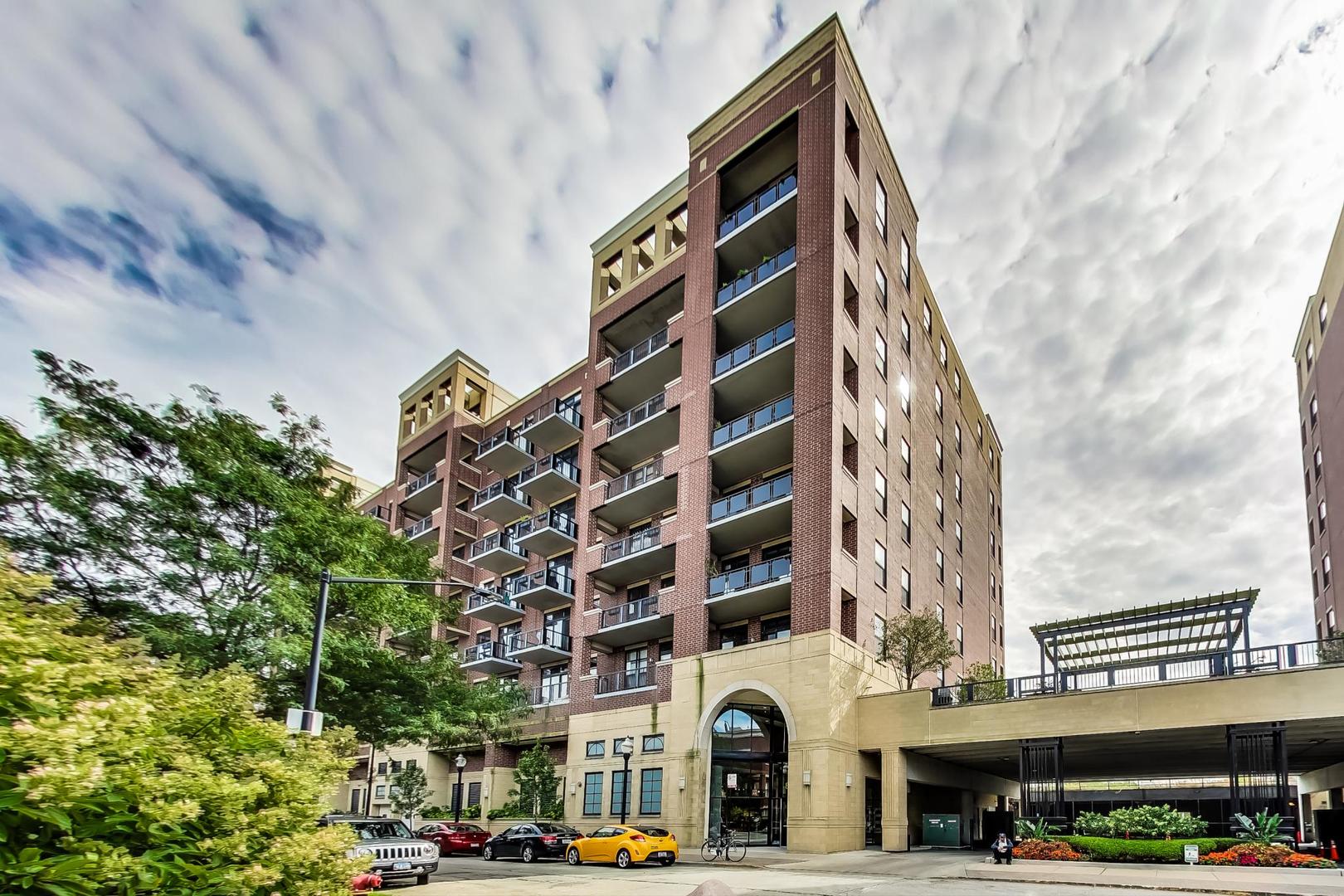 811 West 15th Place, Unit 606 Chicago, IL 60608 - Photo 1 of 22 a front view of multi story residential apartment building with yard and car parked