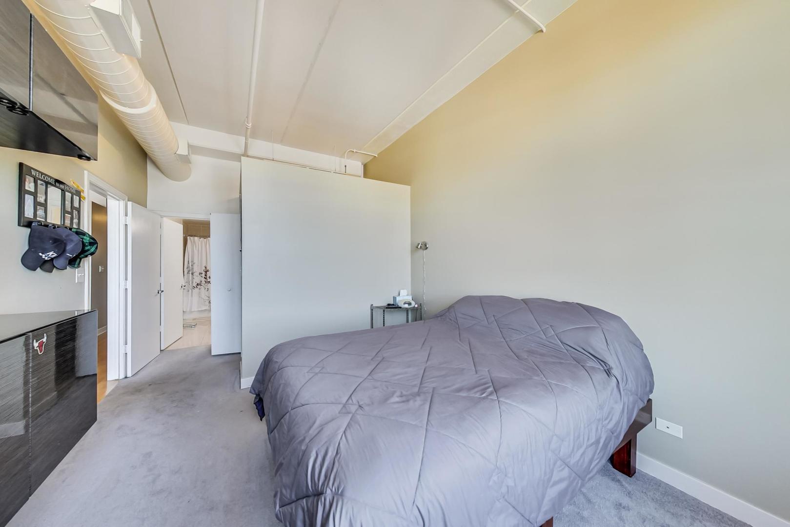 811 West 15th Place, Unit 606 Chicago, IL 60608 - Photo 12 of 22 a bedroom with a bed and a fireplace