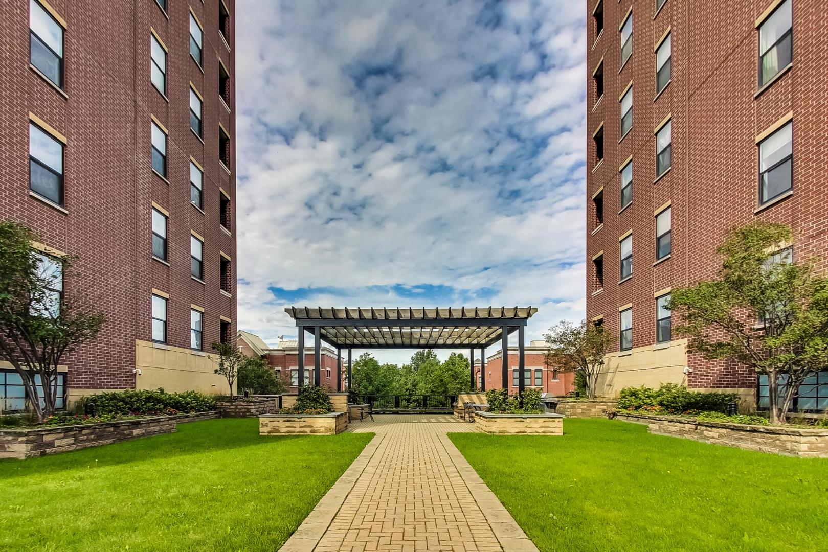 811 West 15th Place, Unit 606 Chicago, IL 60608 - Photo 19 of 22 a view of a brick building next to a yard