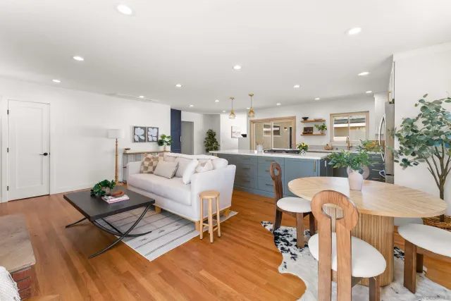 a living room with furniture a dining table and kitchen view