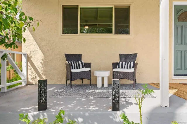 a view of a white house with swimming pool and sitting area