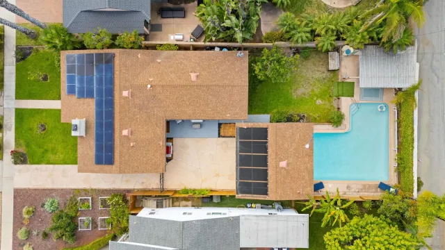 an aerial view of a house with a yard