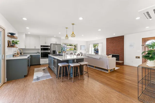 a large kitchen with a table and chairs in it