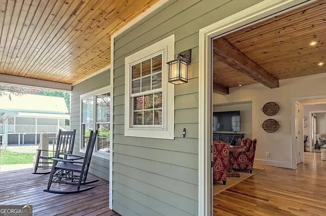 a view of a patio with table and chairs and wooden floor