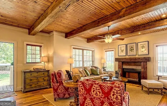 a living room with furniture a fireplace and wooden floor