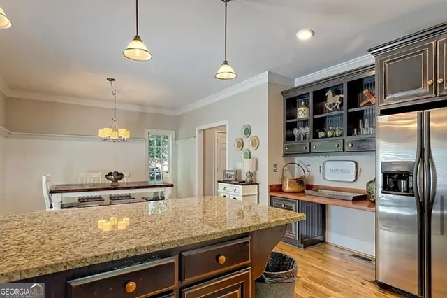 a kitchen with stainless steel appliances granite countertop a sink a stove and a refrigerator