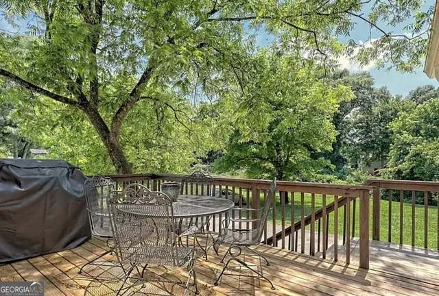 a view of balcony with wooden floor and fence