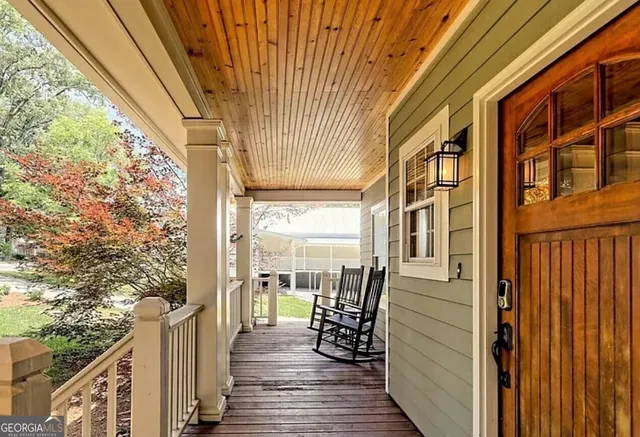 a view of a balcony with wooden floor and stairs